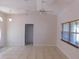 Well-lit living room features tile flooring, neutral paint, and a ceiling fan at 4677 Nw 46Th Ave, Ocala, FL 34482