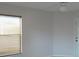 Window view of a neutrally decorated room with tan tiled floor, and wooden blinds at 4677 Nw 46Th Ave, Ocala, FL 34482