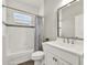Bright bathroom with white cabinetry, stylish fixtures, and neutral-toned tile accents at 4806 Nw 8Th Ter, Ocala, FL 34475