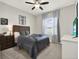 Comfortable bedroom with natural light, ceiling fan, and dark-stained wood accents at 4806 Nw 8Th Ter, Ocala, FL 34475