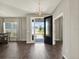 Elegant foyer with hardwood floors, a modern chandelier, and a view of the front yard through the glass door at 4806 Nw 8Th Ter, Ocala, FL 34475