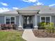 Inviting front porch with a glass-paned door, manicured landscaping, and classic architectural details at 4806 Nw 8Th Ter, Ocala, FL 34475