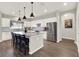 Modern kitchen with white cabinets, stainless steel appliances, granite countertops, and a large island at 4806 Nw 8Th Ter, Ocala, FL 34475
