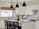 Bright kitchen featuring an island with seating, pendant lighting, white cabinets, and updated fixtures at 4806 Nw 8Th Ter, Ocala, FL 34475