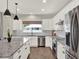 Spacious kitchen with stainless steel appliances, granite counters, and ample storage space in white cabinetry at 4806 Nw 8Th Ter, Ocala, FL 34475