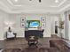 Bright living room boasts a large entertainment center, stylish furnishings, and wood-look tile flooring at 4806 Nw 8Th Ter, Ocala, FL 34475