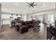 Open-concept living room showcasing the modern kitchen, dining space and beautiful wood-look tile floors at 4806 Nw 8Th Ter, Ocala, FL 34475