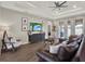 Spacious living room features an entertainment center, lots of natural light, and wood-look tile flooring at 4806 Nw 8Th Ter, Ocala, FL 34475