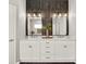Stunning primary bathroom with dual vanity sink, modern lighting, and decorative wood wall at 4806 Nw 8Th Ter, Ocala, FL 34475