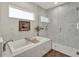 Elegant bathroom features a standalone shower, soaking tub, and a stylish vanity at 4806 Nw 8Th Ter, Ocala, FL 34475