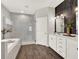 Elegant bathroom with a standalone shower, soaking tub, and dual sink vanity at 4806 Nw 8Th Ter, Ocala, FL 34475
