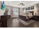 Bedroom features a large window, dark wood furniture, an area rug and a ceiling fan at 4806 Nw 8Th Ter, Ocala, FL 34475