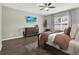 Comfortable bedroom features hardwood floors, modern ceiling fan, and a flatscreen TV at 4806 Nw 8Th Ter, Ocala, FL 34475