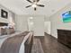 Spacious main bedroom boasts hardwood floors, a ceiling fan, and a connecting en suite bathroom at 4806 Nw 8Th Ter, Ocala, FL 34475