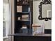 A close up of the office showcasing built-in shelving, a mirror and a table lamp at 4806 Nw 8Th Ter, Ocala, FL 34475