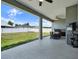 Spacious covered patio with outdoor seating, a grill, and a clear view of the backyard at 4806 Nw 8Th Ter, Ocala, FL 34475