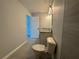 Bathroom featuring a single vanity, toilet, and tiled shower at 4928 Sw Evergreen Ct, Dunnellon, FL 34431