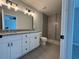 Bathroom with a double vanity, granite countertop, and tiled walk-in shower at 4928 Sw Evergreen Ct, Dunnellon, FL 34431