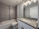 Bathroom featuring a vanity, toilet, and a tiled shower and tub at 4928 Sw Evergreen Ct, Dunnellon, FL 34431