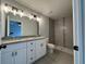 Bathroom with a double vanity, granite countertop, and tiled walk-in shower at 4928 Sw Evergreen Ct, Dunnellon, FL 34431
