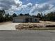 Newly built single Gathering home featuring a paved driveway, attached garage, and neutral paint scheme at 4928 Sw Evergreen Ct, Dunnellon, FL 34431