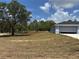 A home with a two car garage and large front lawn at 4928 Sw Evergreen Ct, Dunnellon, FL 34431