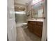 Neutral bathroom with wood vanity, tile floor, and glass shower doors at 4981 Ne 110Th Street Ne St, Anthony, FL 32617