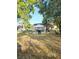 Expansive backyard with a deck, outdoor dining set, and ample space for activities and relaxation at 5365 Sw 111Th Lane Rd, Ocala, FL 34476