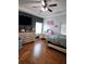 Spacious bedroom with dark accent wall, wood floors, and a modern vanity area at 5365 Sw 111Th Lane Rd, Ocala, FL 34476