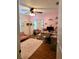 Cozy bedroom with desk area, closet mirror, and sitting area with pink love seat at 5365 Sw 111Th Lane Rd, Ocala, FL 34476