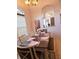 Cozy dining room features a set table, soft lighting, and a view into an adjacent room at 5365 Sw 111Th Lane Rd, Ocala, FL 34476