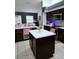 Modern kitchen with white countertops, dark wood cabinets, and stainless-steel appliances at 5365 Sw 111Th Lane Rd, Ocala, FL 34476