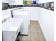 Functional laundry area with a utility sink, washer, dryer, and tiled flooring at 5365 Sw 111Th Lane Rd, Ocala, FL 34476