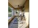 Cozy screened patio with wicker furniture, ceiling fan, and outdoor rug, perfect for relaxing at 5365 Sw 111Th Lane Rd, Ocala, FL 34476
