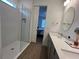 Stylish bathroom with dual sinks, modern vanity, and a glass-enclosed shower, connecting to bedroom at 5785 Sw 87Th Court Rd, Ocala, FL 34481
