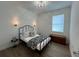 Cozy bedroom featuring a decorative bed frame, wood-look tile, and natural lighting at 5785 Sw 87Th Court Rd, Ocala, FL 34481