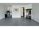 Garage featuring epoxy floors, white walls, water heater, storage and door to house at 5785 Sw 87Th Court Rd, Ocala, FL 34481