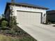 Attached two-car garage with modern door and well-maintained landscaping at 5785 Sw 87Th Court Rd, Ocala, FL 34481