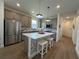 Well-lit kitchen featuring a quartz island, stainless steel appliances, and open layout at 5785 Sw 87Th Court Rd, Ocala, FL 34481