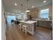 Open-concept kitchen featuring a spacious island, quartz countertops, and stainless steel appliances at 5785 Sw 87Th Court Rd, Ocala, FL 34481