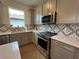 A well-designed kitchen with stainless steel appliances and decorative backsplash at 5785 Sw 87Th Court Rd, Ocala, FL 34481