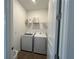 Functional laundry room with modern washer and dryer units and built-in shelving for storage at 5785 Sw 87Th Court Rd, Ocala, FL 34481