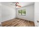 Bedroom featuring a wood floor, ceiling fan, and a window for a light and airy feel at 6057 Se 39Th Ave, Ocala, FL 34480