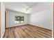 Bright bedroom with wood floors, a ceiling fan and a window providing ample natural light at 6057 Se 39Th Ave, Ocala, FL 34480