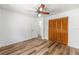 Bedroom featuring wood floors, ceiling fan, and closet, offering comfort and functionality at 6057 Se 39Th Ave, Ocala, FL 34480