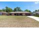 Charming brick home with red shutters, well-manicured lawn, and attached two-car garage at 6057 Se 39Th Ave, Ocala, FL 34480