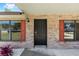 Close-up of a front door featuring brick facade, decorative shutters, and a well-lit entryway at 6057 Se 39Th Ave, Ocala, FL 34480