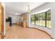 Eat-in kitchen featuring tile flooring, ample counter space, wooden cabinets, and a large bay window at 6057 Se 39Th Ave, Ocala, FL 34480