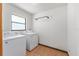 Functional laundry room with a washer, dryer and a window for natural light at 6057 Se 39Th Ave, Ocala, FL 34480