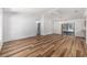 Open-concept living room features wood flooring, vaulted ceiling, and natural light from a window at 6057 Se 39Th Ave, Ocala, FL 34480